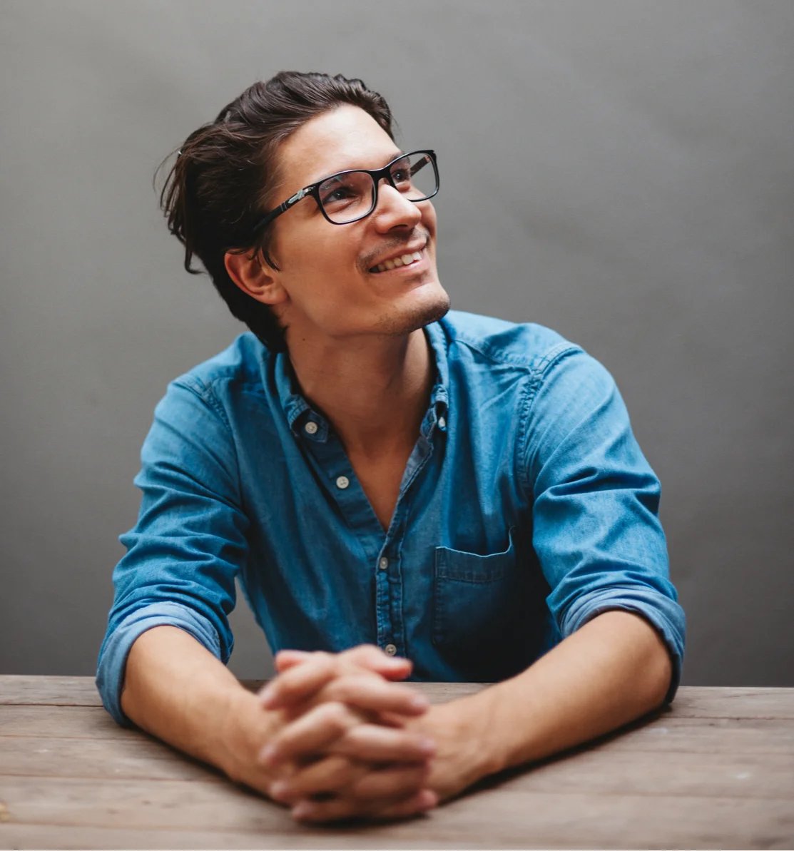 Man sitting at desk smiling.